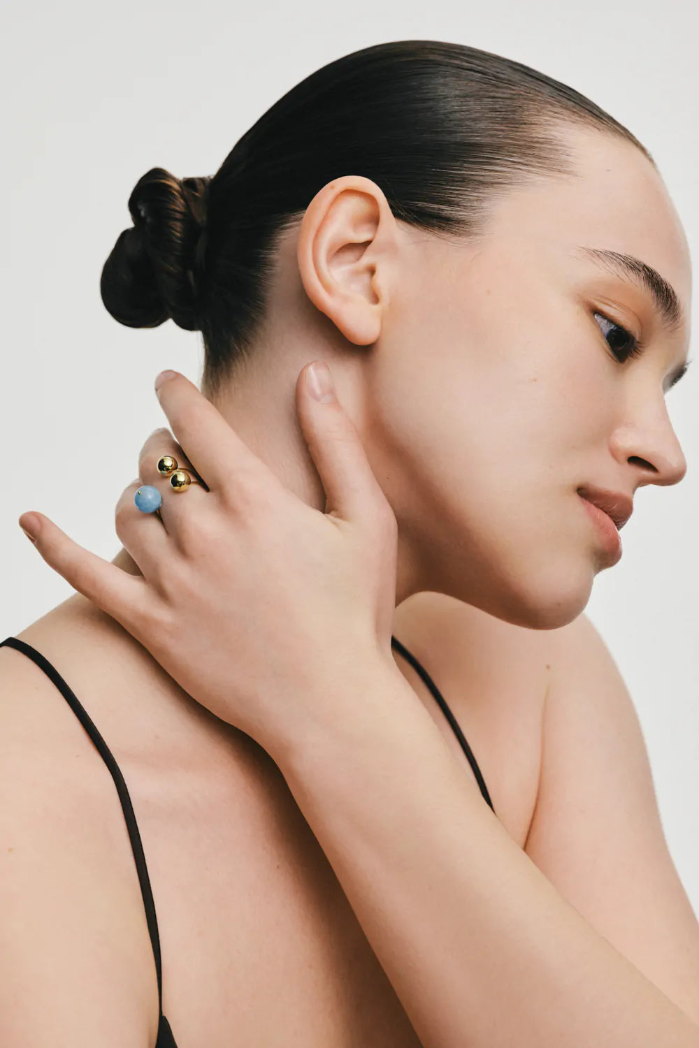 Ring with two gold and one aquamarine spheres, yellow gold
